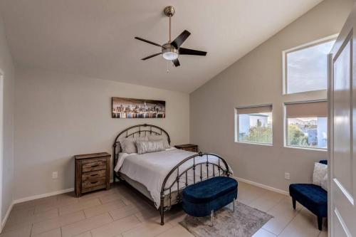 a bedroom with a bed and a ceiling fan at Mid Century Modern Game Room in Tucson