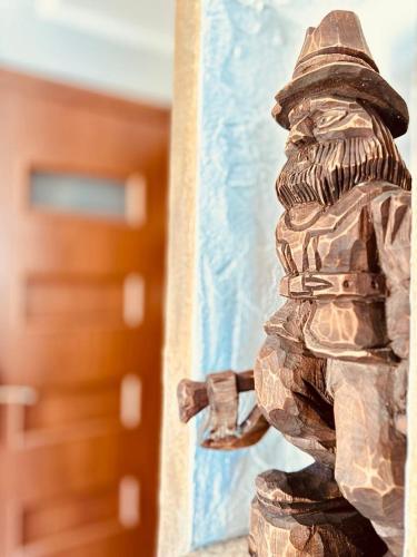a statue of a fireman standing next to a building at Agroturystyka Wilkowyja in Mchawa