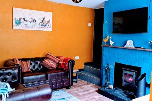 a living room with a couch and a fireplace at The Bolthole in Nailsworth
