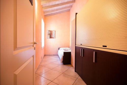 a hallway with a room with a bed and a door at Al Podestà - Centro Storico in Mantova