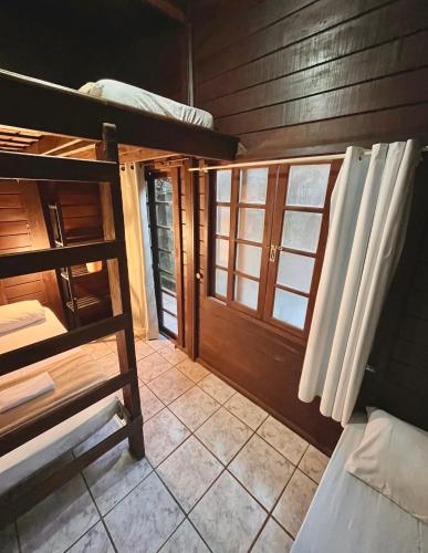 a room with a bunk bed and a door at Vibe House Hostel in Florianópolis