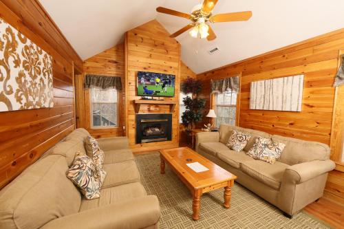 a living room with a couch and a tv at Ivy Falls by Eden Crest in Pigeon Forge