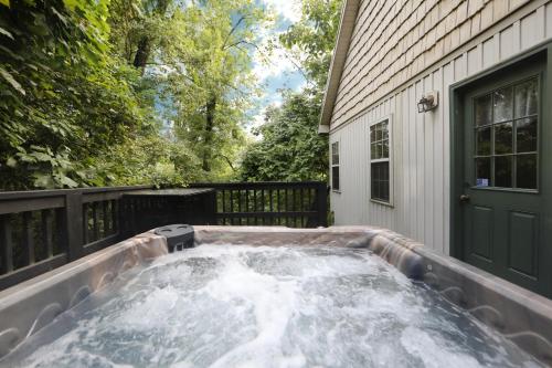 a hot tub in the backyard of a house at Ivy Falls by Eden Crest in Pigeon Forge