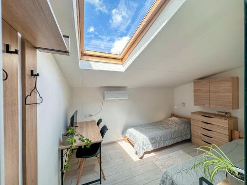 a bedroom with a bed and a desk and a window at "АпартСервic" жк Сонячний квартал in Solochin