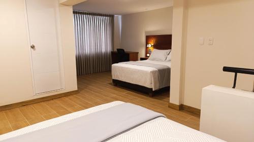 a hotel room with two beds and a bedroom at Casa Pucllana Miraflores - Hotel Boutique in Lima