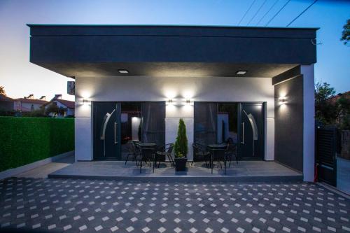 a house with a patio with tables and chairs at Sofia Luxury Apartments in Gevgelija