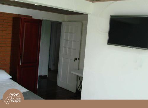 a room with a tv on a wall with a bed at Full house, 11BR, 12BA, 10 min from SJO Airport in Heredia