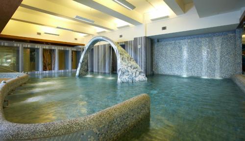a pool with a water fountain in a room at Fleur de Chine Hotel in Yuchi