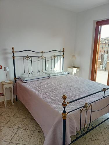 a large bed in a bedroom with a window at CasaMare Luxury Siderno in Siderno Marina