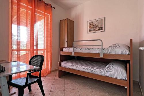 a room with two bunk beds and a table and a desk at Villa Belvedere - Baia azzurra in Torre San Limato