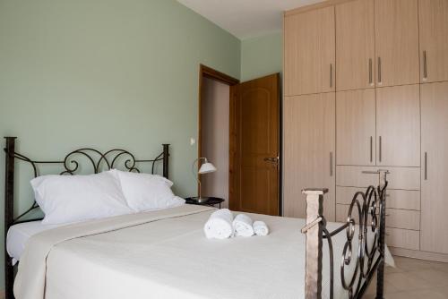 a bedroom with a bed with two towels on it at Villa Discover Evia - With Private Jacuzzi in Aliveri