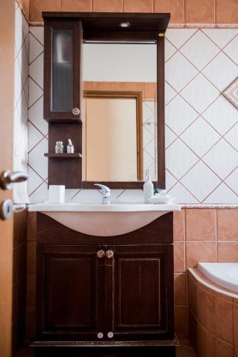 a bathroom with a sink and a mirror at Villa Discover Evia - With Private Jacuzzi in Aliveri