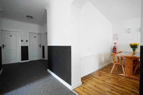 a living room with a table and a desk at Wileńska Pokoje in Słupsk