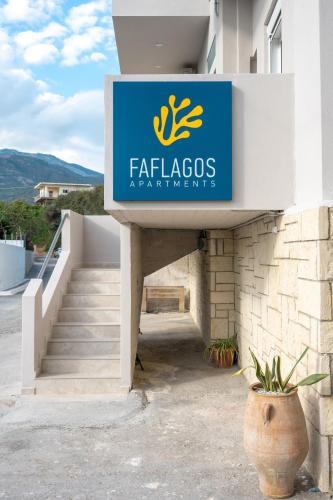 a sign for a flaxos restaurant on a building at Faflagos Apartments in Psari Forada