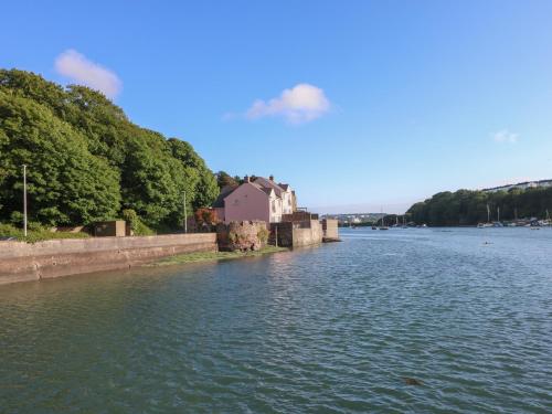 a river with a house in the middle of it at Goldfinch in Milford Haven