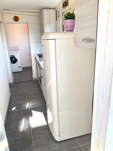 a kitchen with a white refrigerator in a room at Eruption1669 in Catania