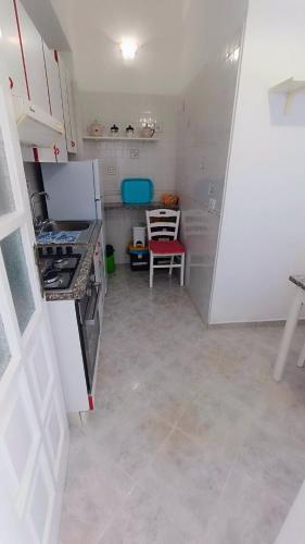 a small kitchen with a stove and a refrigerator at Appartamenti Tina in Villa Restituta in Ischia