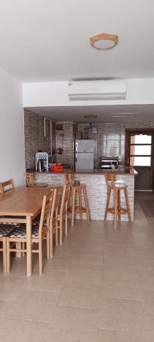 a kitchen with a wooden table and chairs at شالية بقرية بالميرا in Ain Sokhna