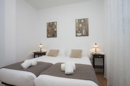 バレンシアにあるSingularStays Plaza Redondaのベッドルーム1室(大きな白いベッド1台、タオル付)