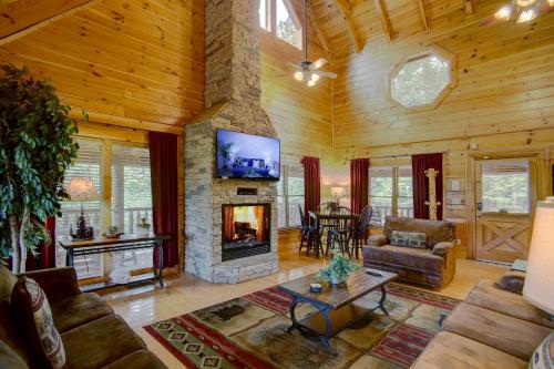 a living room with a fireplace and a tv at Belvedere by Eden Crest in Sevierville