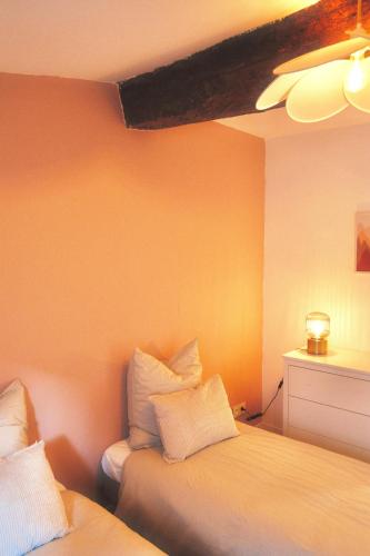 a bedroom with two beds with white pillows at Appartement Duplex Le Mimosa Parking a proximité vue exceptionnelle in Grasse