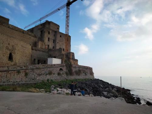 a man and a child standing in front of a castle at La Mansarda in Quarto