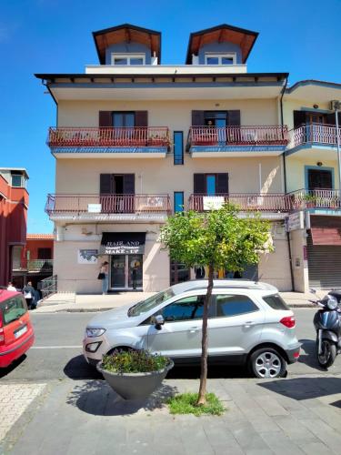 a silver car parked in front of a building at La Mansarda in Quarto