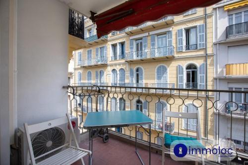 - un balcon avec une table en face d'un bâtiment dans l'établissement Studio Air-conditioned district of the Musicians, à Nice