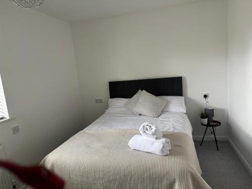 a bedroom with a bed with a towel on it at Do not book having difficulty removing from page house is not bookable in Derby