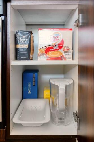 a refrigerator filled with food and a blender at Empire State View - Luxury Apt - Shuttle to NYC in Hoboken