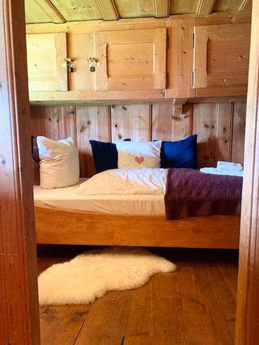 a bedroom with a bed with a wooden wall at Ferme Pasquier - Farmhouse with panoramic view - 1000 m2 garden in Avry devant Pont