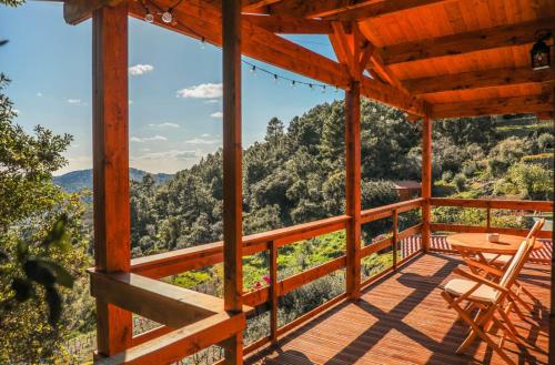 a wooden porch with a table and chairs on it at Quinta Altamira in Portalegre