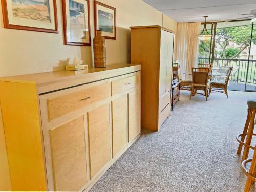 a kitchen with a refrigerator and a dining room at Maui Sunset B211 in Kihei