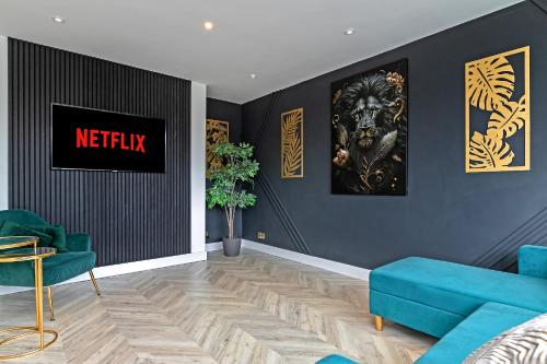 a living room with a blue couch and a wall at Supreme Luxury Apartment-Close to Airport-Free Parking in Luton