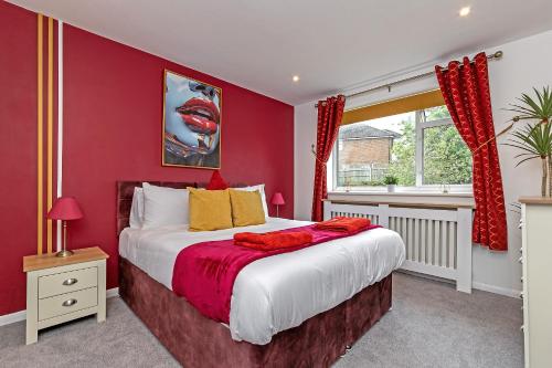 a red bedroom with a bed and a window at Supreme Luxury Apartment-Close to Airport-Free Parking in Luton