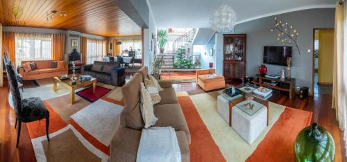 a living room with a couch and a table at Consuls Residence in Ponta Delgada