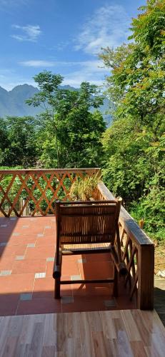 a wooden bench sitting on top of a deck at Hill House in Mai Chau