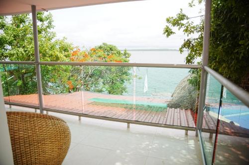 a room with a view of the ocean from a balcony at Hotel Isla Real in Tierra Bomba