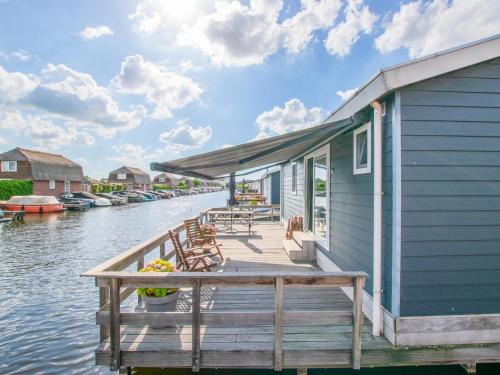 a house on a dock on a body of water at Purperreiger 24-34 in Breukelen