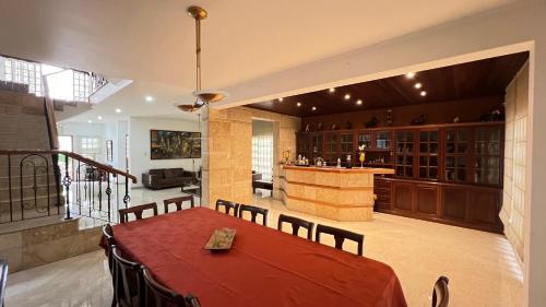 a dining room with a table and a bar at Rora in Caracas
