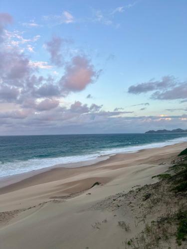 a sandy beach with the ocean in the background at Bruma Homes in Ponta do Ouro