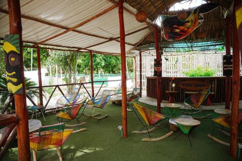 a group of chairs and tables under a tent at Hotel Isla Real in Tierra Bomba