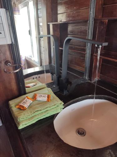 a bathroom with a sink and a bath tub at Tiny House - Los Cedros in Tartagal