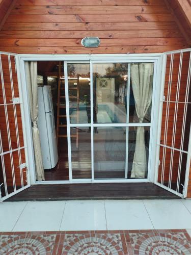 an open sliding glass door in a house at Tiny House - Los Cedros in Tartagal