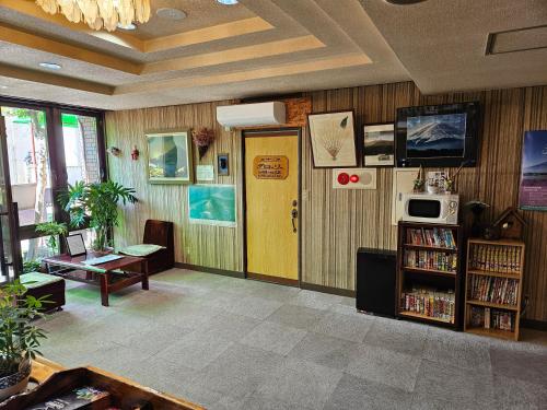 a library with a yellow door and a book shelf at Plaza Inn Kawaguchiko in Fujikawaguchiko