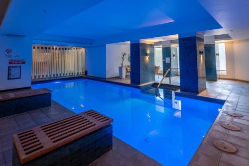 a large swimming pool with a bench in the middle at Perfect 4 Bedroom Penthouse close to Casino in Melbourne
