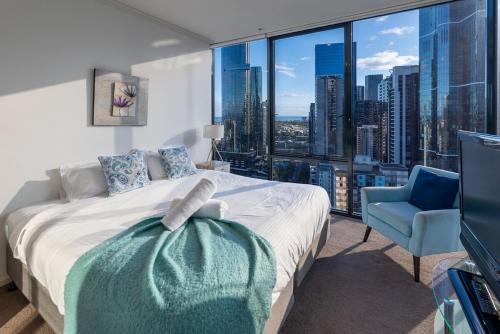 a bedroom with a bed and a view of a city at Perfect 4 Bedroom Penthouse close to Casino in Melbourne