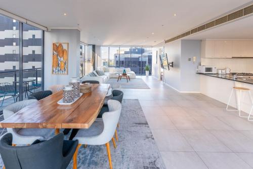 a dining room with a wooden table and chairs at Perfect 4 Bedroom Penthouse close to Casino in Melbourne