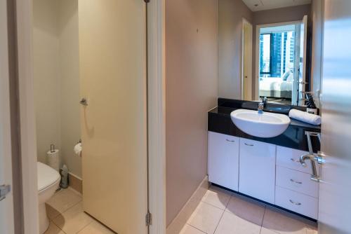a bathroom with a sink and a toilet at Perfect 4 Bedroom Penthouse close to Casino in Melbourne