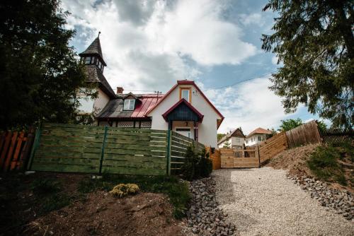 a large house with a fence in front of it at Skyway Borsec Connection Hideaway in Borsec